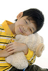 child hugging stuffed animal